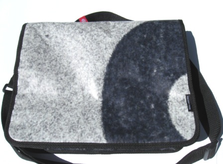 A recycled laptop bag made from Powershop's Electricity vs Power billboard campaign.